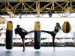 Pareja pateando saco en entrenamiento de kick boxing